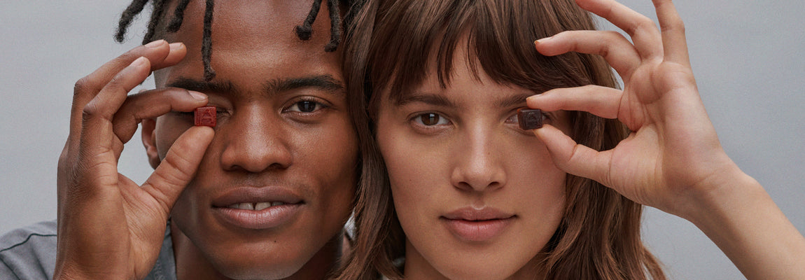 male and female model holding gummy to their eye respectively